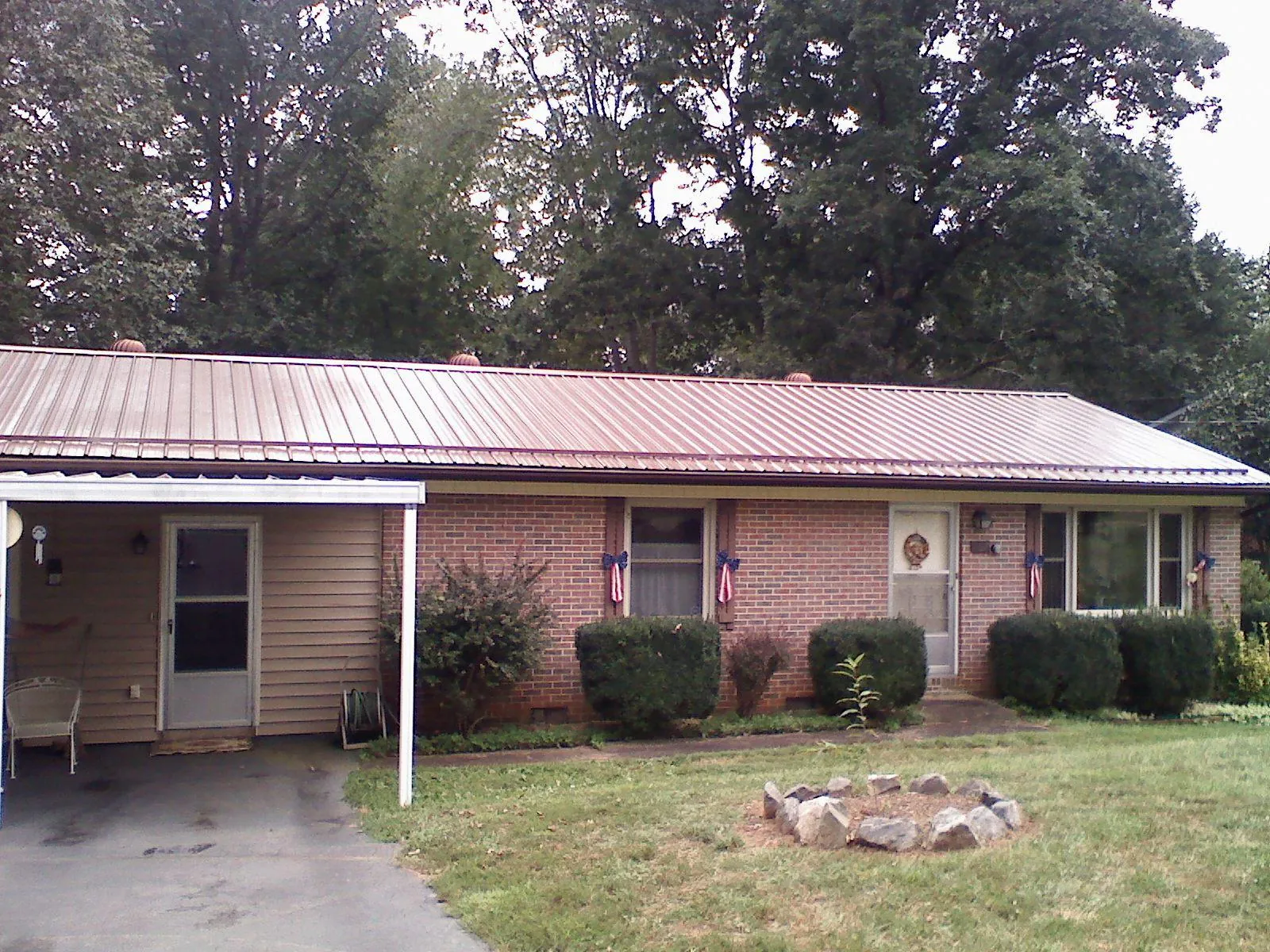 Bronze metal roof and carport on a brick ranch home — Roof Repair work by our crew in Germantown